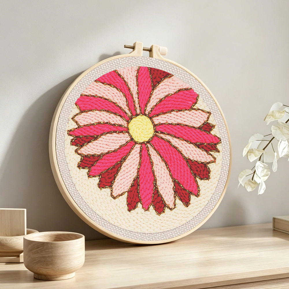 Finished pink geometric sunburst flower artwork displayed on a wall