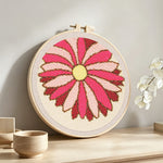 Finished pink geometric sunburst flower artwork displayed on a wall